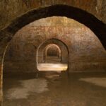 Vista di Napoli sotterranea con dettagli delle antiche gallerie e architetture nascoste.